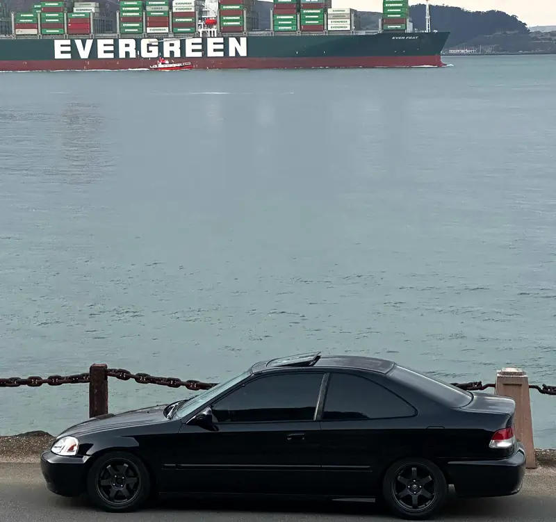 NMR1 Racing car 44, a black Honda Civic EJ8, parked at Fort Point below the Golden Gate Bridge